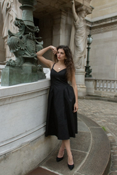 a lady in a black slip dress